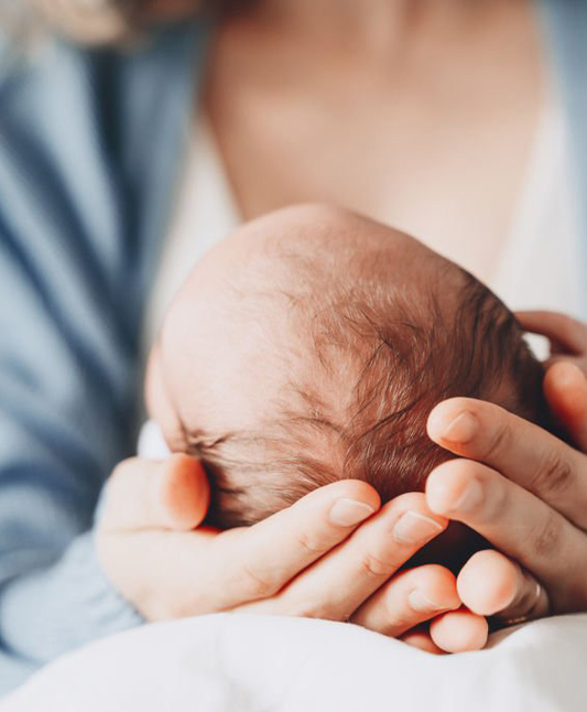Mother cupping baby's head