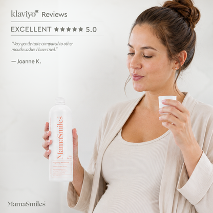 A pregnant woman in a beige cardigan holds a white bottle of MamaSmiles mouthwash and a small white cup, with Klaviyo Reviews text and a 5-star rating shown on a light background.