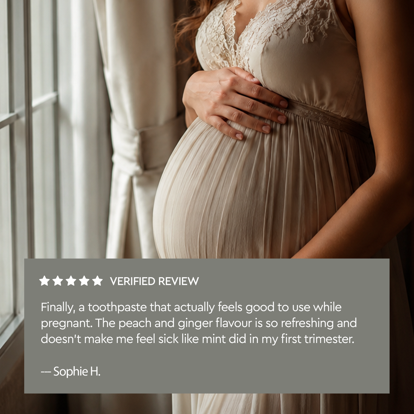 A pregnant woman in a cream lace-trimmed gown cradles her belly, with a gray verified review overlay showing customer feedback for a toothpaste.